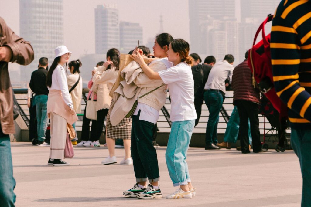 Tourists capturing moments at a popular destination, showcasing the adaptation to modern travel experiences.